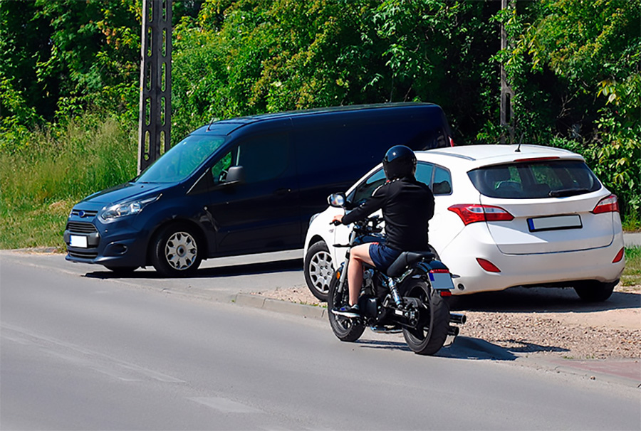 Car driving infront of a motorcycle